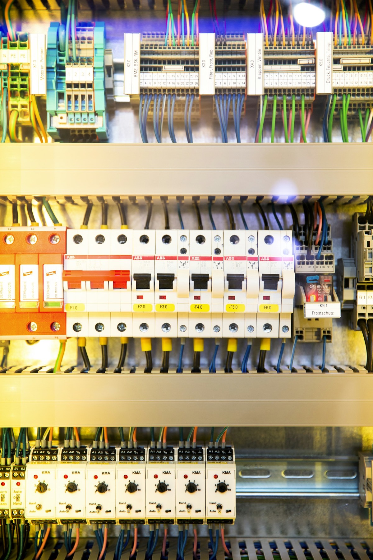 Close-up of a distribution board with labelled circuit breakers and wiring
