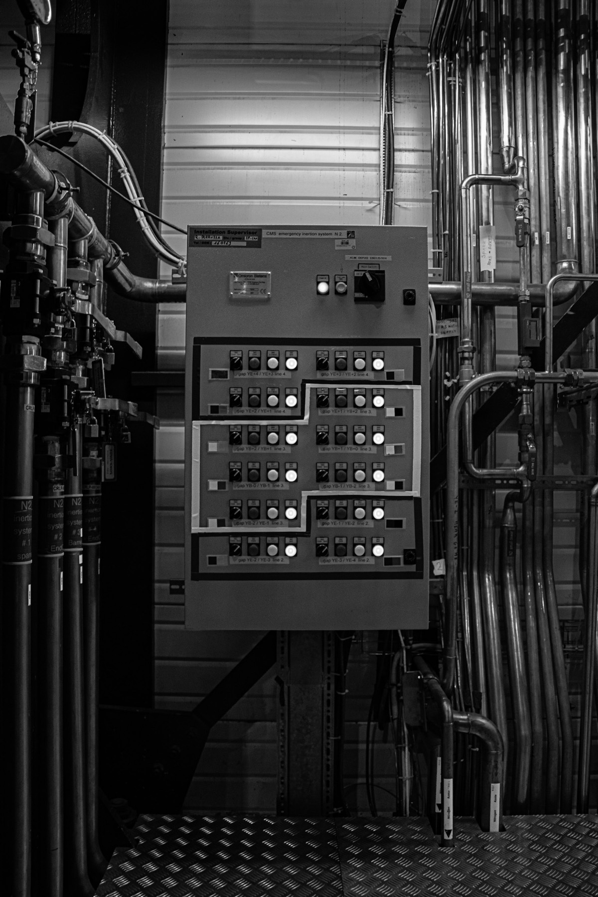 Industrial control panel surrounded by plant pipework