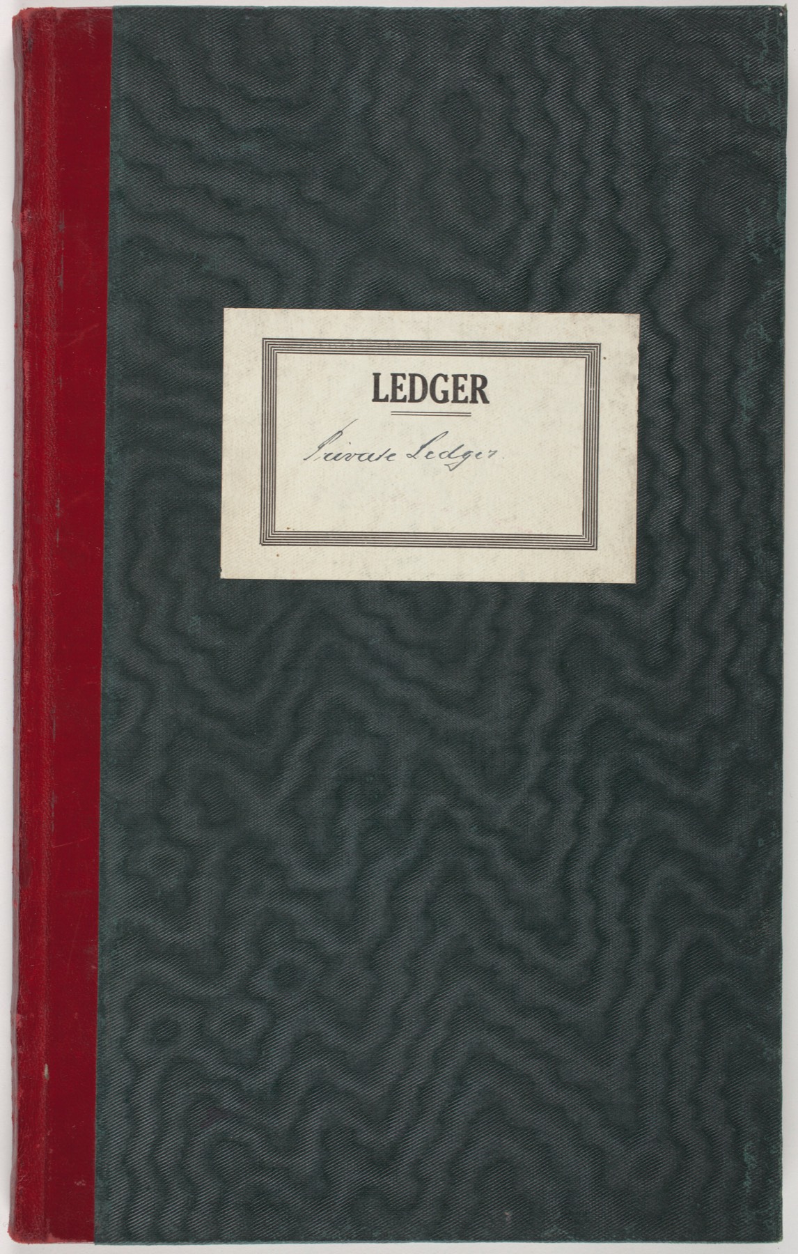 A private ledger bound in deep green moiré cloth with an oxblood leather spine and a ruled paper label reading Ledger.
